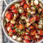 up close caprese salad in white bowl