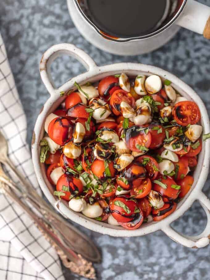 chopped caprese salad in a white serving dish.