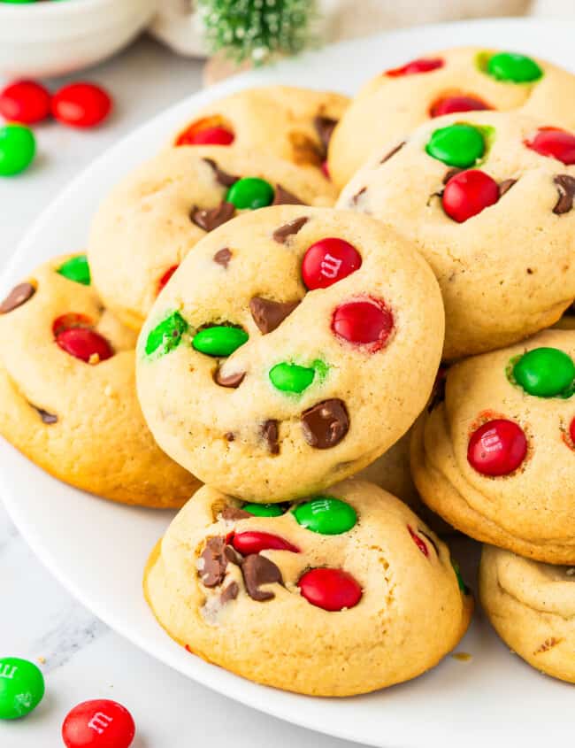 A plate of cookies with m & m's on it.