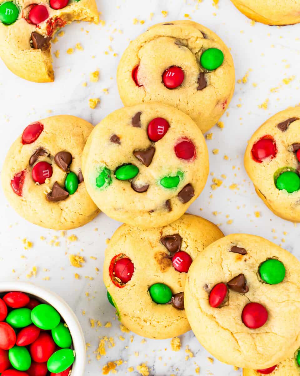 cookies filled with M&Ms and chocolate chips, arranged on parchment paper.