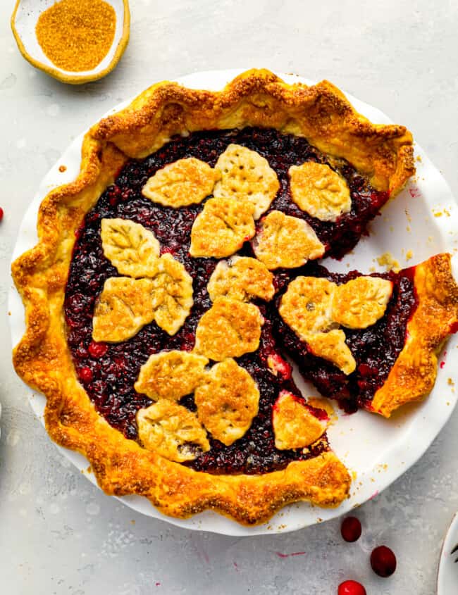 A cranberry pie with a slice taken out.