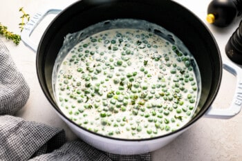 Peas in a pot with cream and herbs.