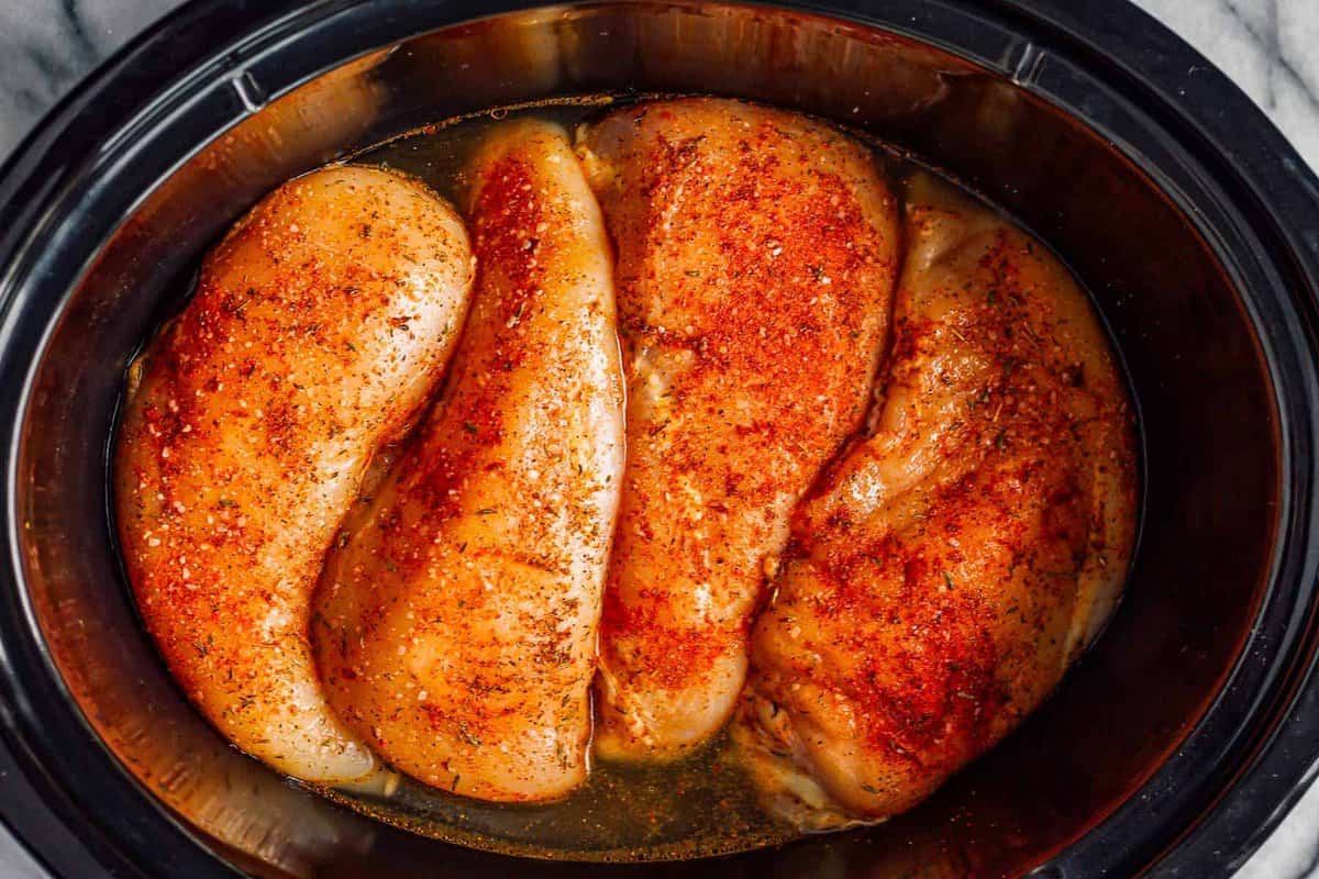 cooking chicken breasts in a slow cooker.
