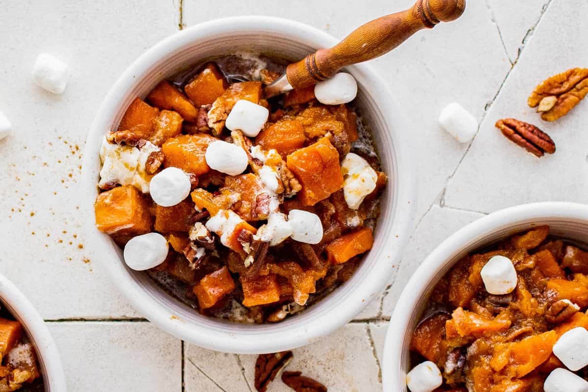 up close white bowl of crockpot sweet potato casserole