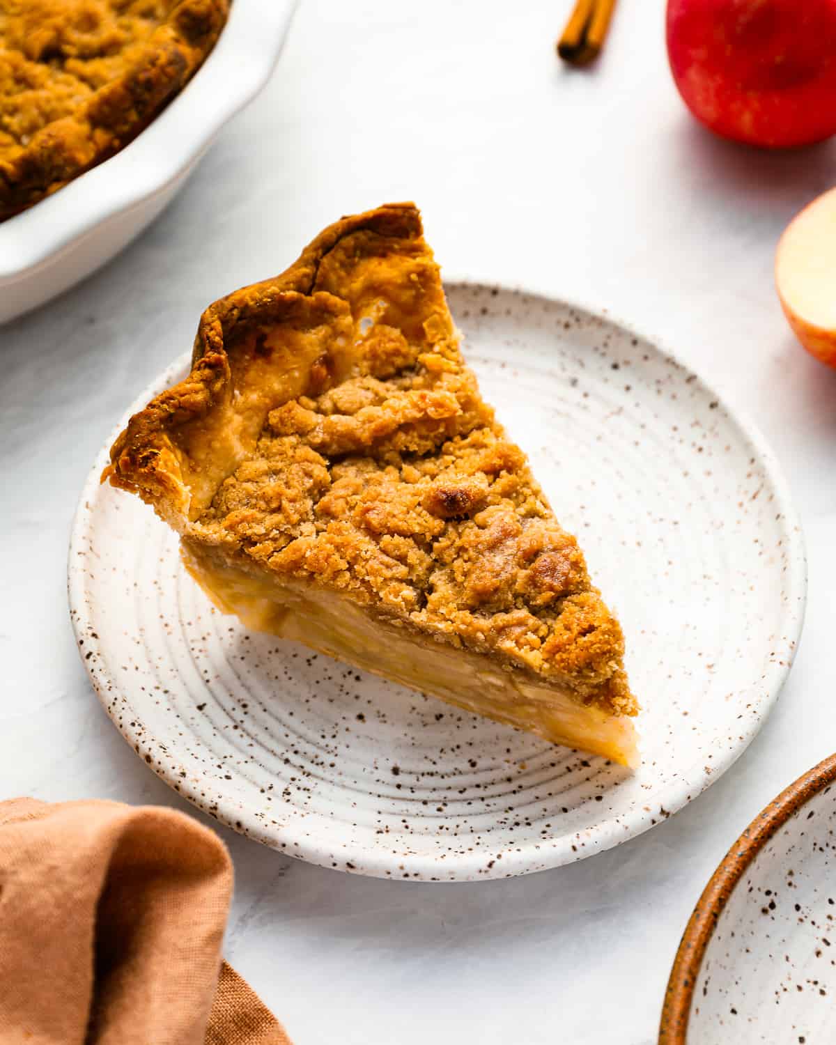 A slice of Dutch apple pie on a plate.