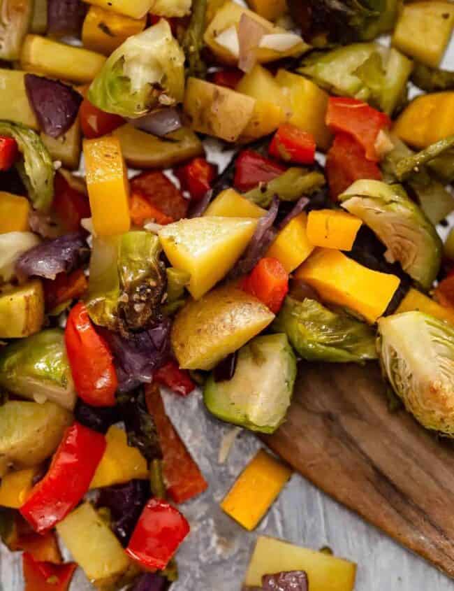 close up view of chopped roasted vegetables on a pan