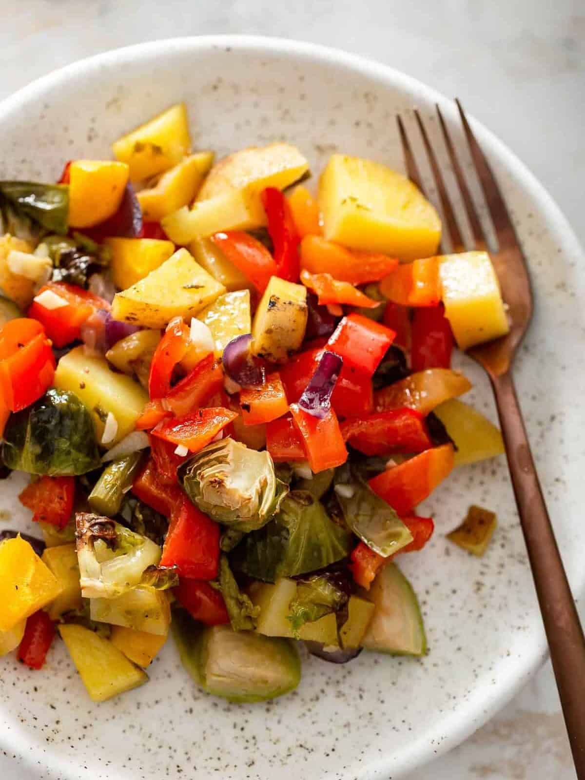 cooked brussels sprouts, squash, potatoes on a plate