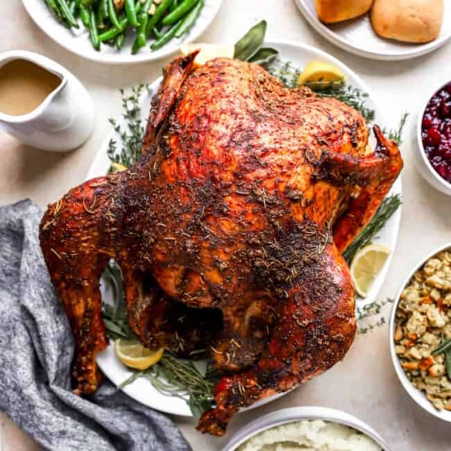 Thanksgiving dinner with a roasted turkey and side dishes.