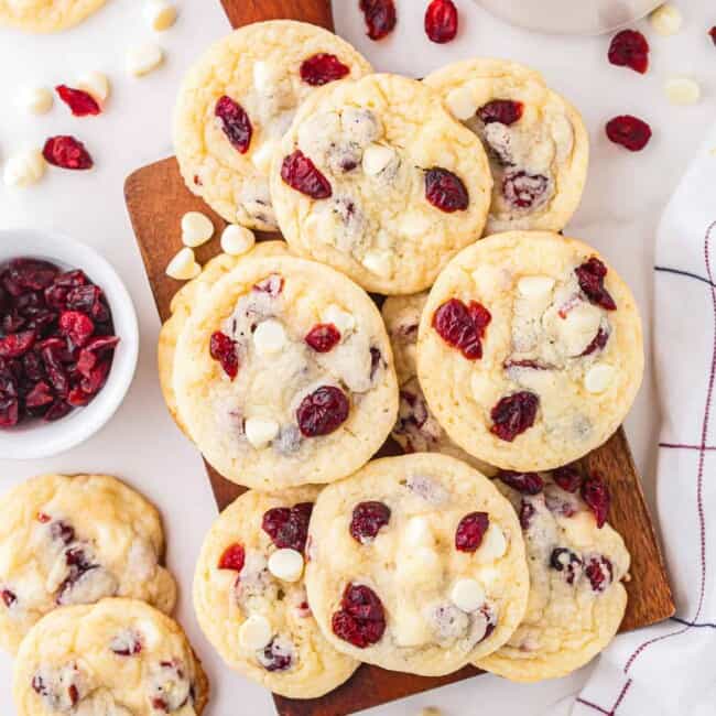 Cranberry white chocolate cookies on a cutting board.