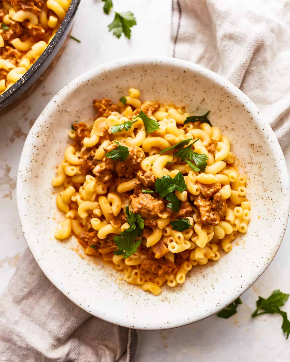 a serving of cheeseburger helper in a speckled bowl.
