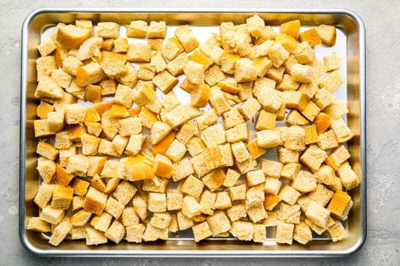 A baking sheet filled with pieces of croutons.