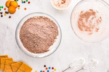 A bowl of chocolate chips, marshmallows, and other ingredients.