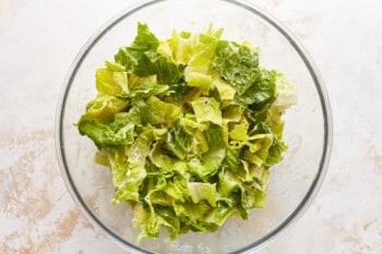 Lettuce in a glass bowl on a table.