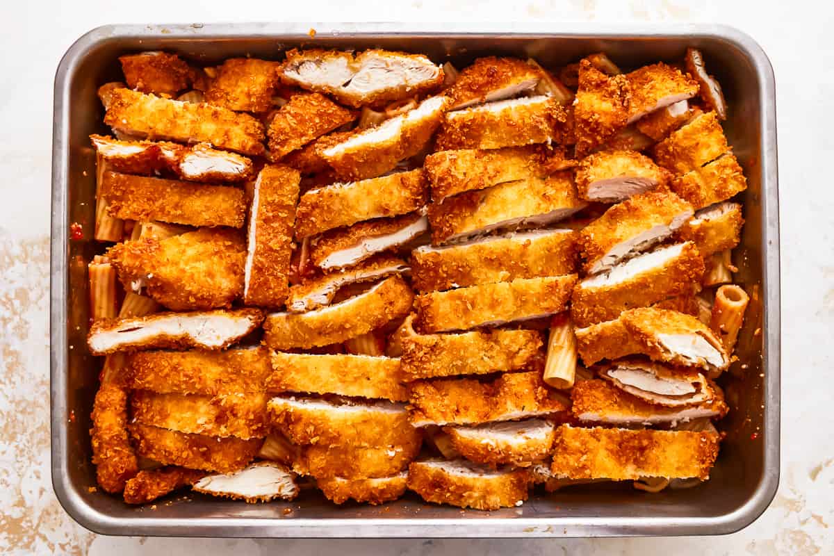 Fried chicken in a baking pan on a white background.