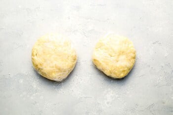 Two pieces of dough on a white surface.