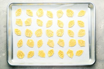 A baking sheet with yellow leaves on it.