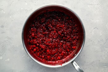 Cranberry sauce in a pan on a grey background.