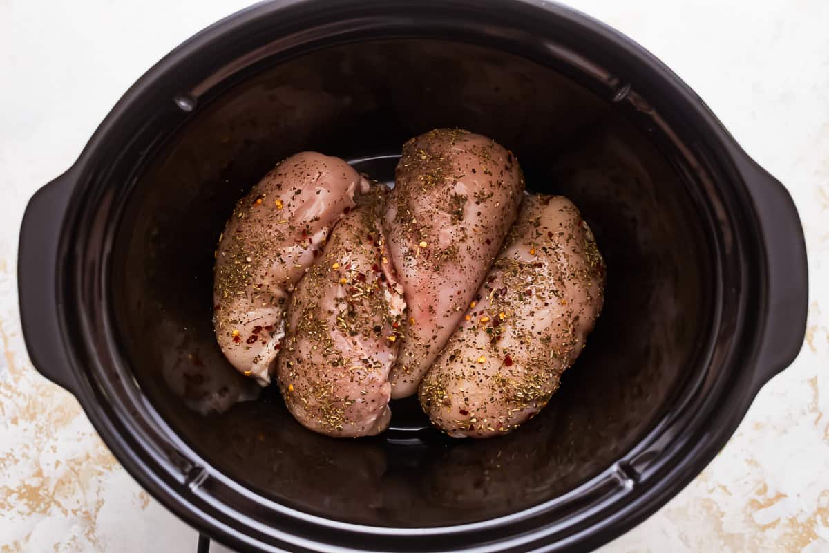 Chicken breasts in a slow cooker.