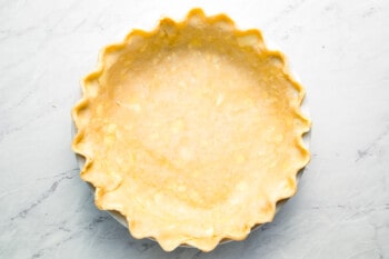 An image of a pie crust on a marble surface.