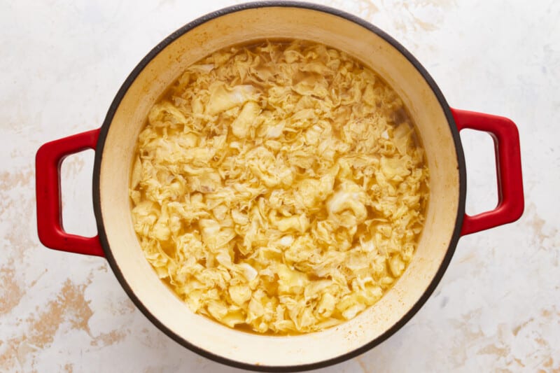 A pot full of mashed potatoes on a table.