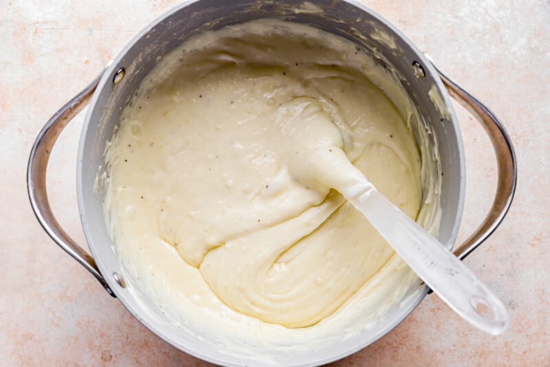 A bowl of batter with a spoon in it.