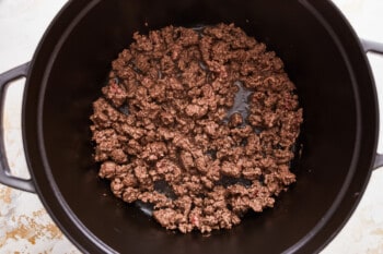 A black skillet filled with ground beef.