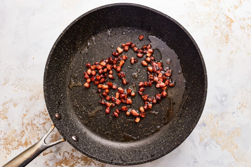 Pancetta in a frying pan.