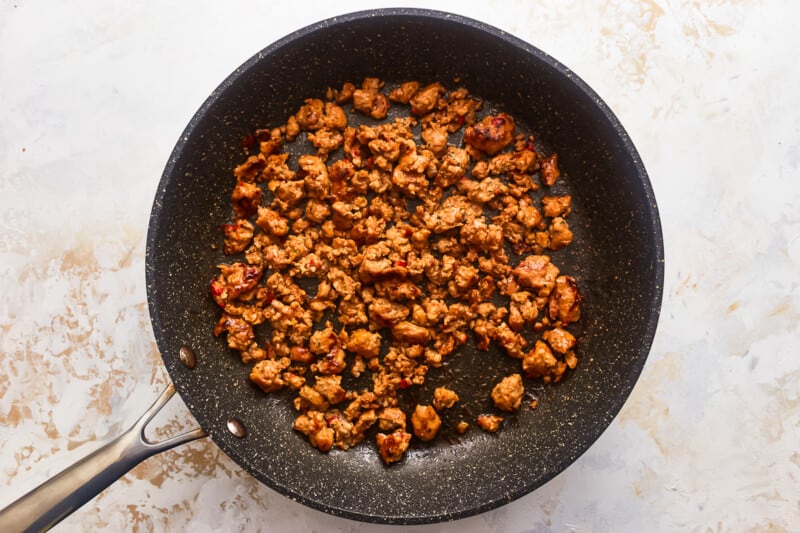 A frying pan with meat in it.