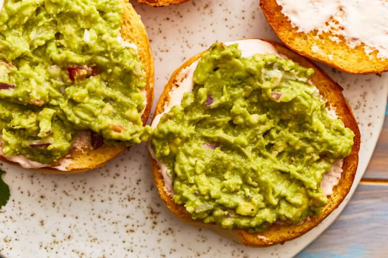 Avocado toast with guacamole on a plate.