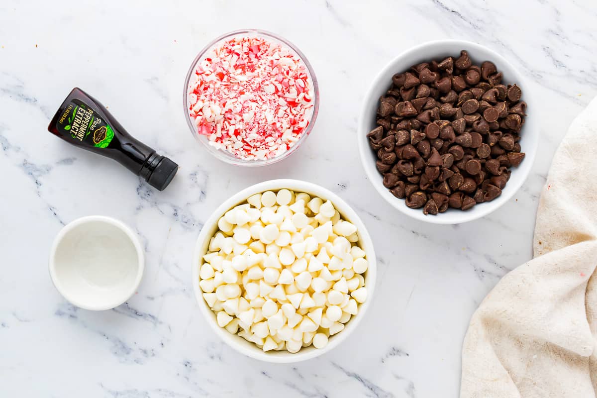 A bowl of chocolate chips, candy canes, and sprinkles.