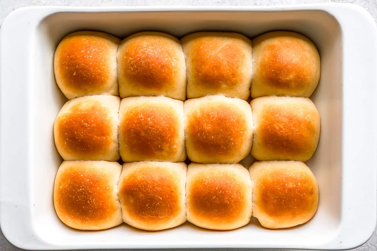 Bread rolls in a white baking dish.