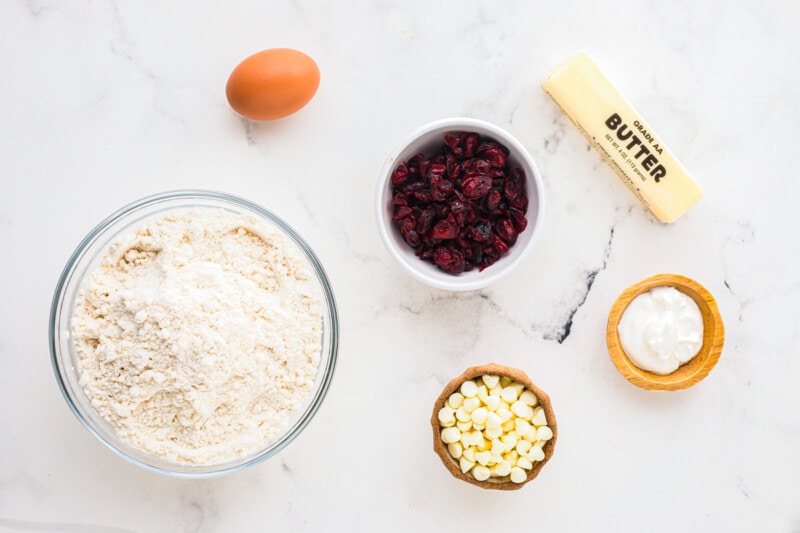 Ingredients for cranberry cranberry pancakes on a marble table.