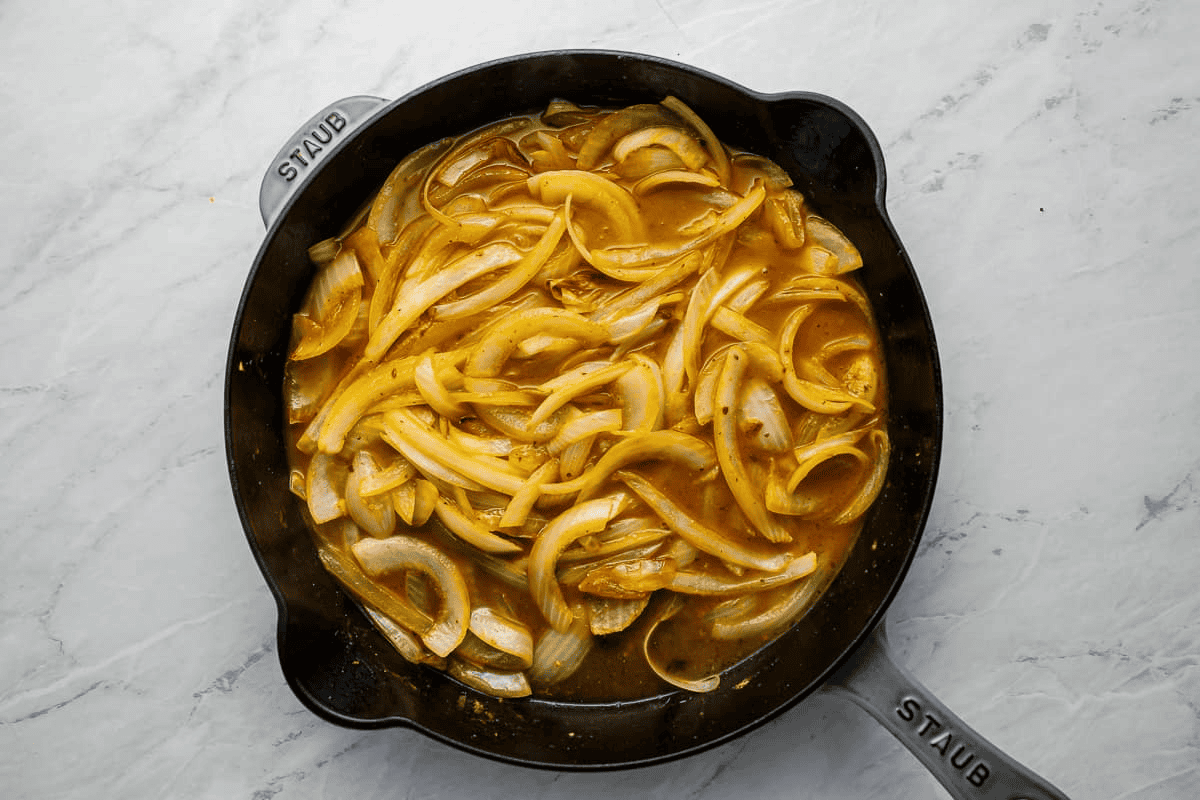 onions and chicken broth simmering in a pan