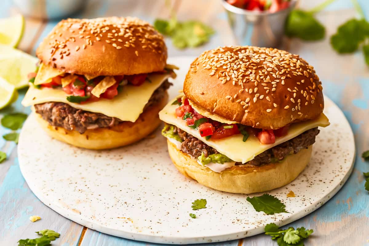 Two Mexican burgers on a serving platter.