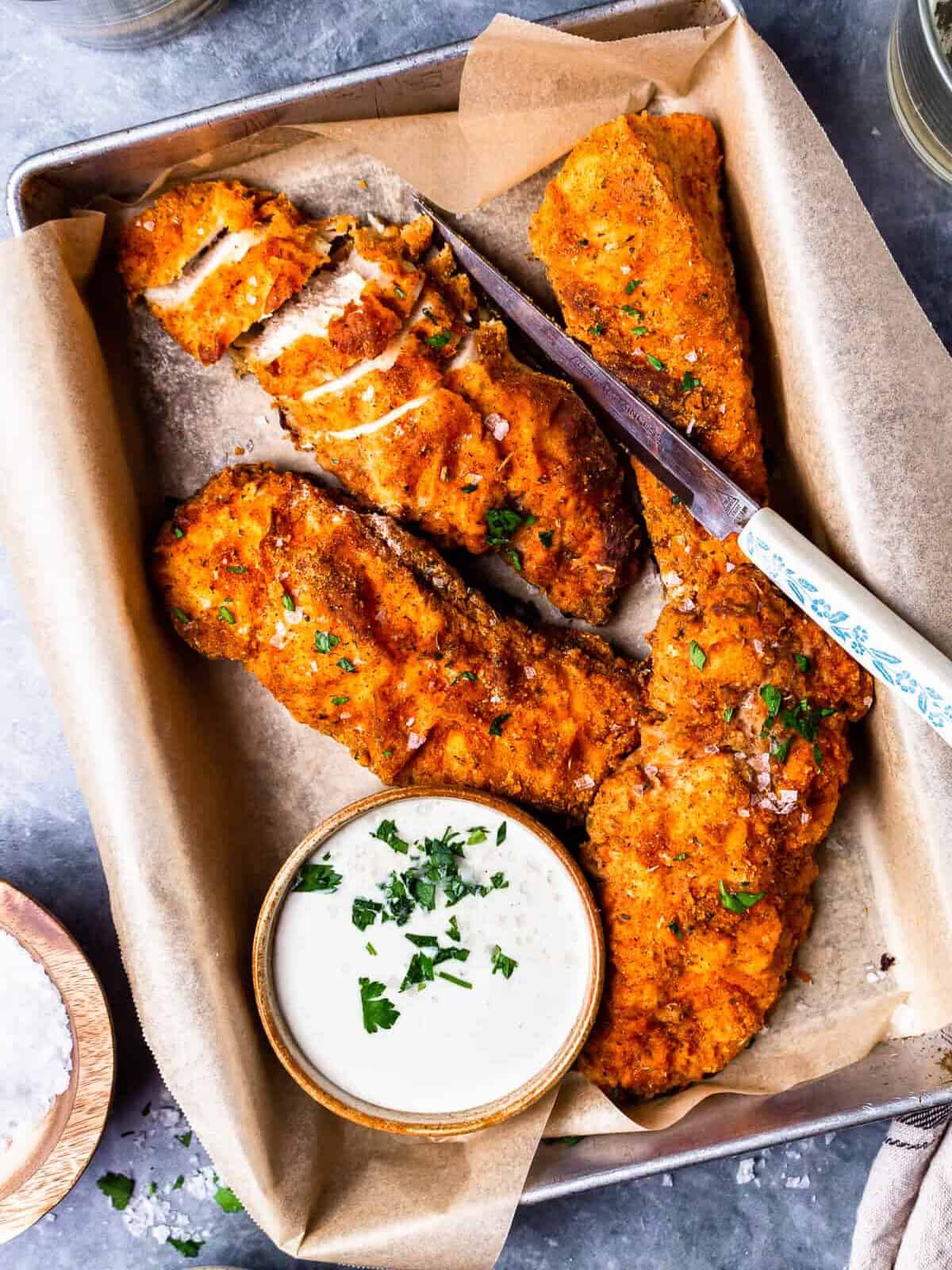 four pieces of oven fried chicken on a tray
