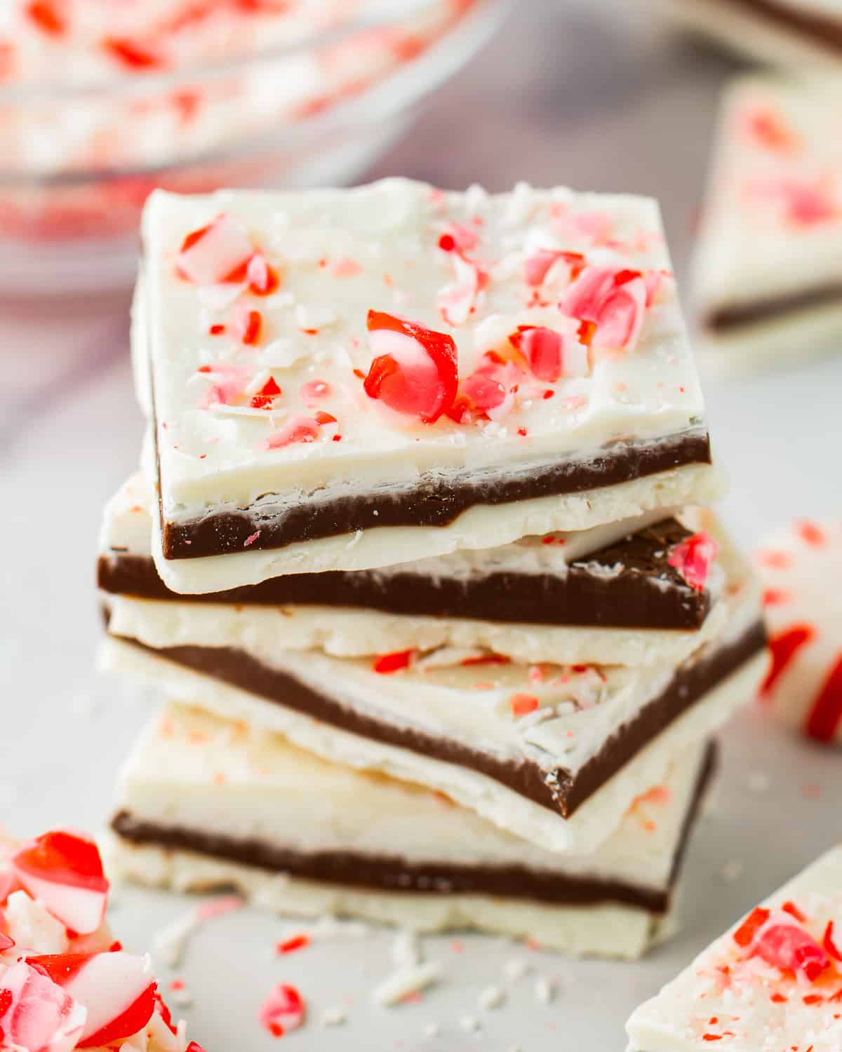 pieces of white chocolate peppermint bark stacked on top of each other.