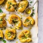 smashed potatoes on a baking sheet with parchment paper
