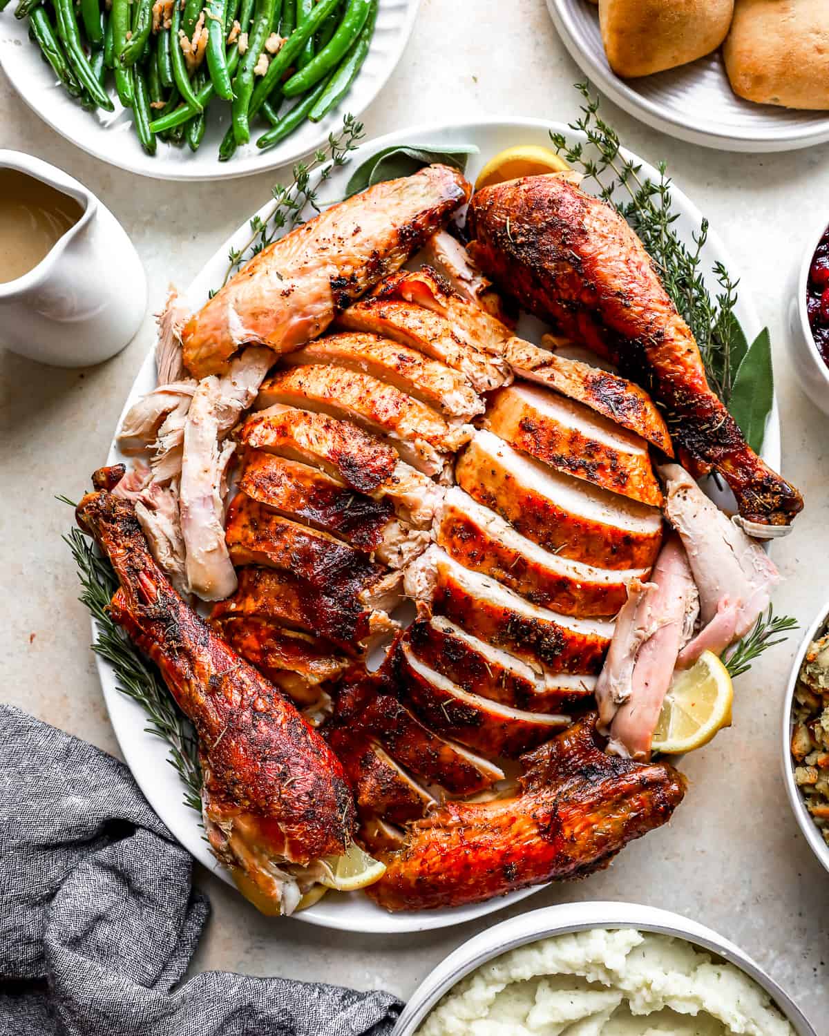 Thanksgiving dinner with a whole smoked turkey, green beans and mashed potatoes.