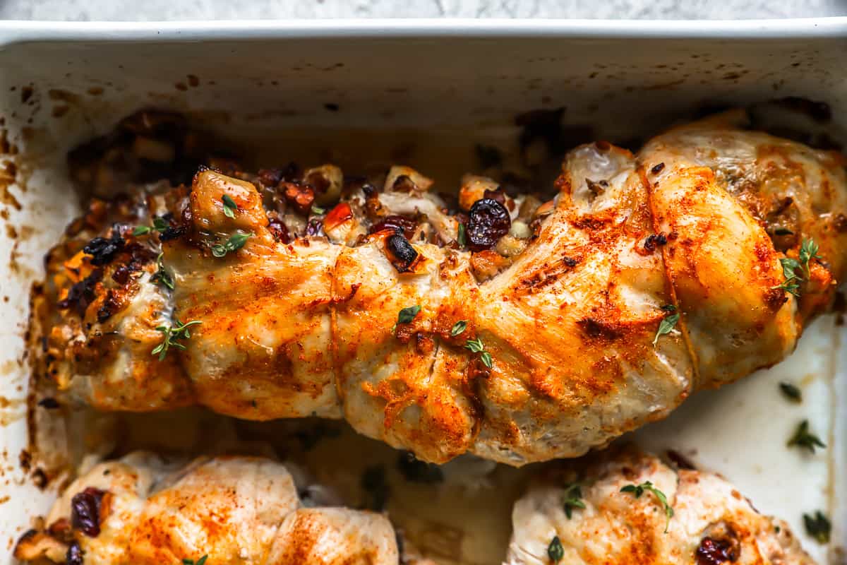 stuffed and rolled turkey breast in a baking dish.