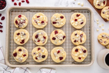 Cranberry white chocolate cookies on a cooling rack.