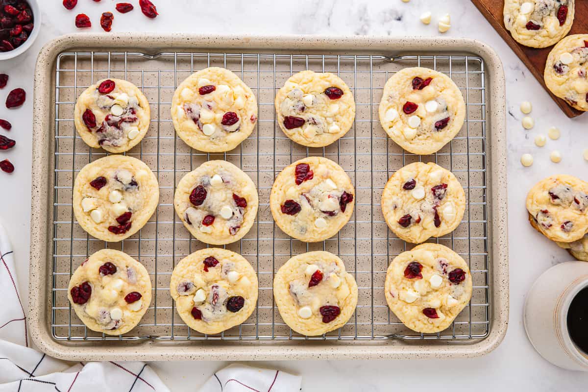 Cranberry white chocolate cookies on a cooling rack.