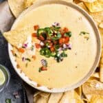 mexican cheese dip with chips and salsa.