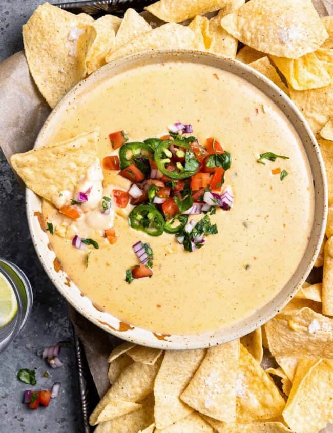 mexican cheese dip with chips and salsa.