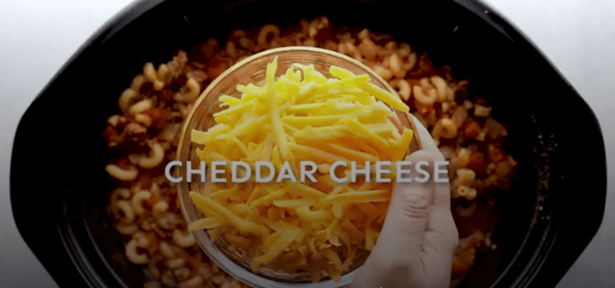 adding cheese to goulash