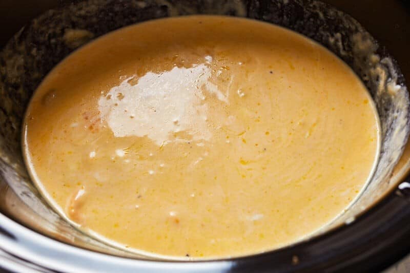 Combining cheese sauce ingredients in the slow cooker.