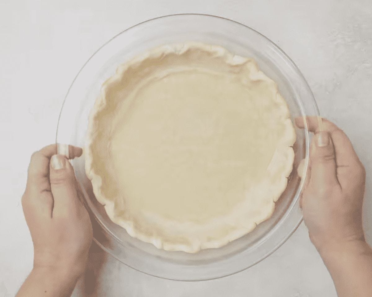 Unbaked pie crust in a glass pie plate. 