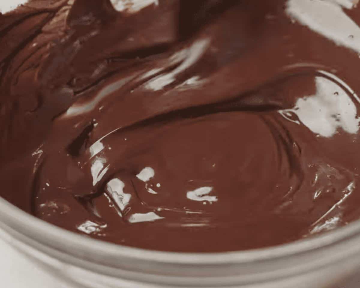Melted chocolate in a glass bowl.