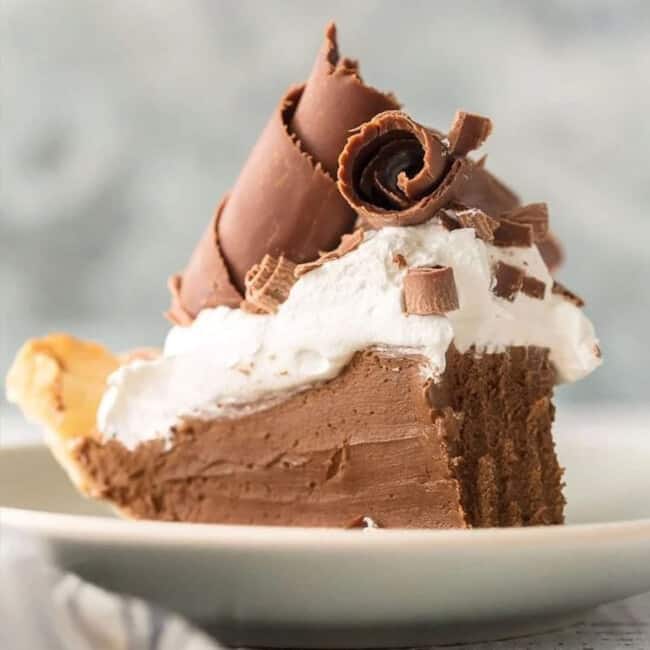 A slice of French silk pie on a white plate.