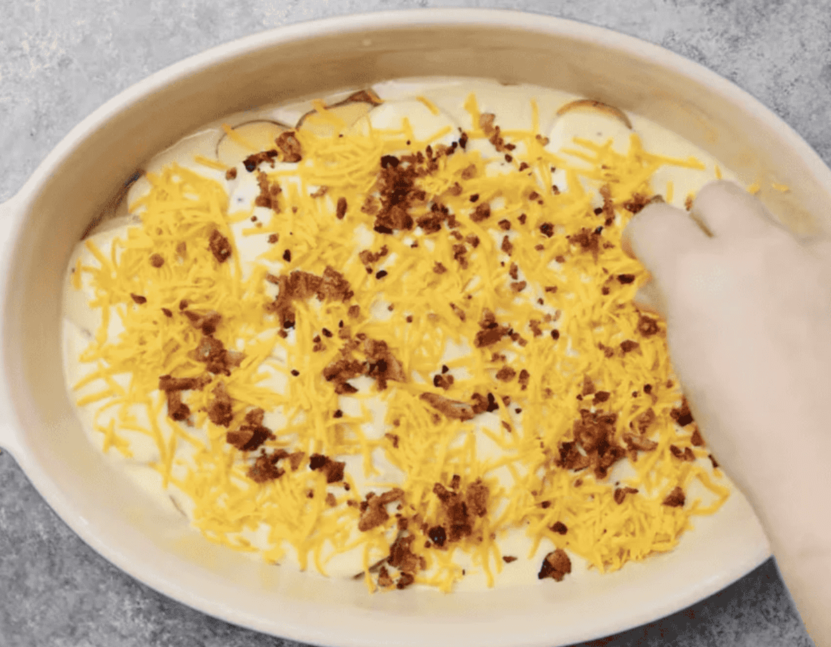 Layering the casserole ingredients in the dish.