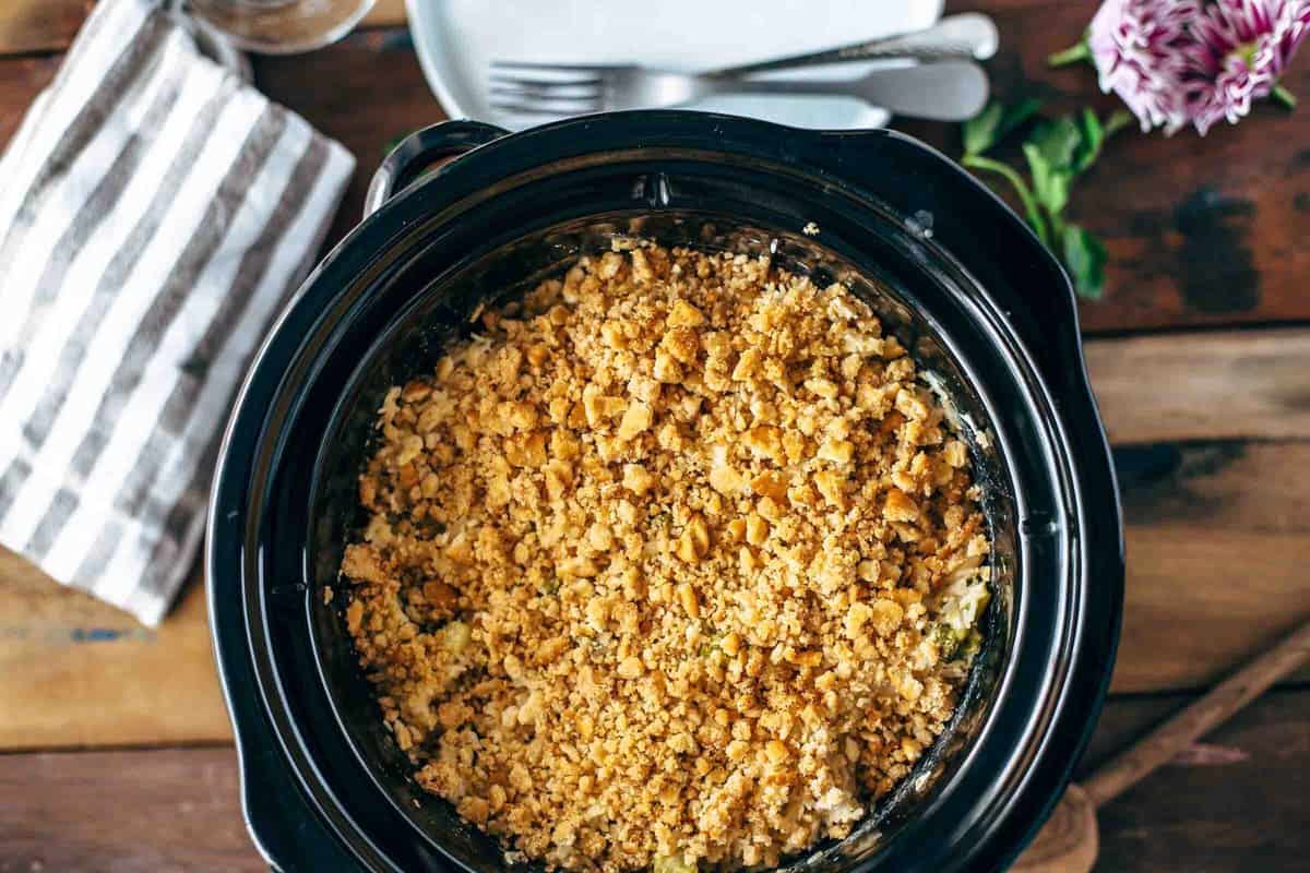 A casserole filled with velveeta, broccoli, and rice cooked in a crock pot.